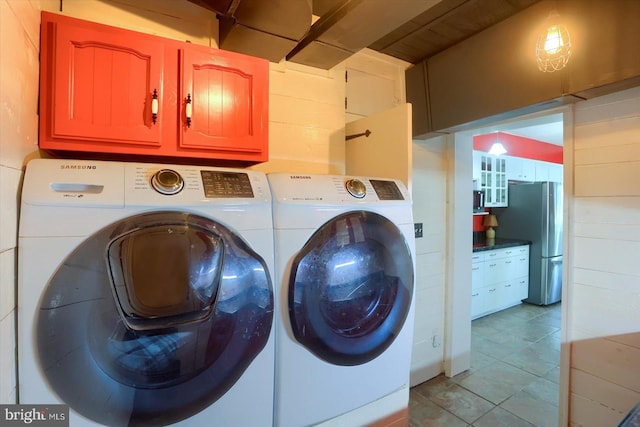 896 Hershey Heights Rd, Hanover, PA 17331 - laundry area featuring washing machine and dryer, cabinet space, and light tile patterned floors