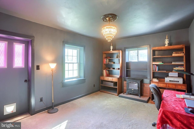 896 Hershey Heights Rd, Hanover, PA 17331 - carpeted office space featuring a wood stove, a chandelier, and baseboards