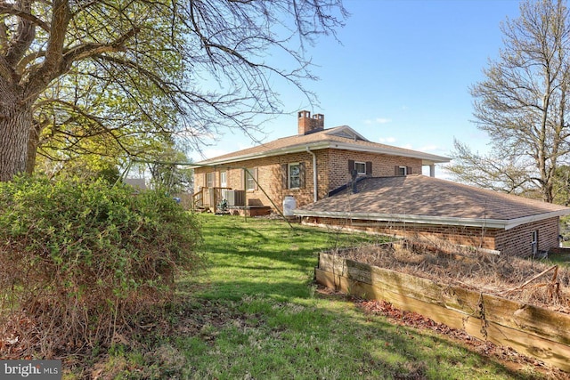 896 Hershey Heights Rd, Hanover, PA 17331 - back of property with brick siding, a chimney, a lawn, and roof with shingles