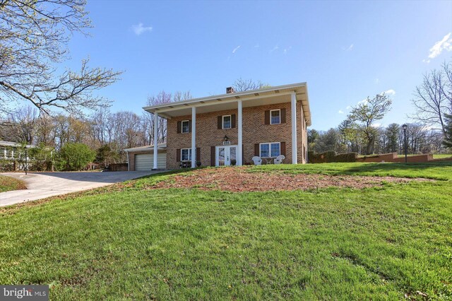 896 Hershey Heights Rd, Hanover, PA 17331 - back of property with brick siding, a chimney, a yard, a garage, and asphalt driveway