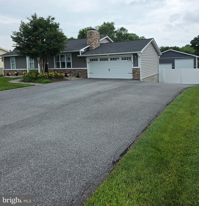 6421 S Church St, Sykesville, MD 21784 - single story home with stone siding, a chimney, and asphalt driveway