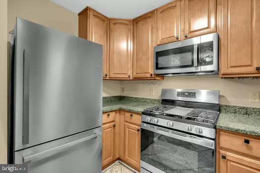 45472 Westmeath Way Unit I 12, Great Mills, MD 20634 - kitchen featuring appliances with stainless steel finishes and stone counters