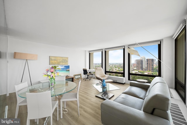 210 Locust St Unit 19Gw, Philadelphia, PA 19106 - living area with light wood-style floors, healthy amount of natural light, a view of city, and floor to ceiling windows