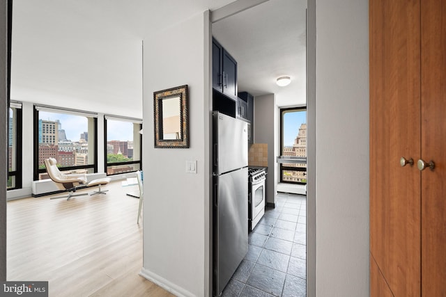 210 Locust St Unit 19Gw, Philadelphia, PA 19106 - kitchen featuring appliances with stainless steel finishes, a city view, and a wall of windows