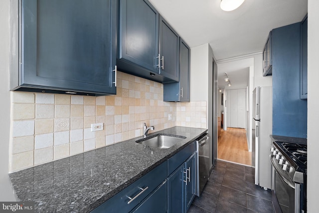 210 Locust St Unit 19Gw, Philadelphia, PA 19106 - kitchen with appliances with stainless steel finishes, dark stone counters, tasteful backsplash, dark tile patterned flooring, and blue cabinetry