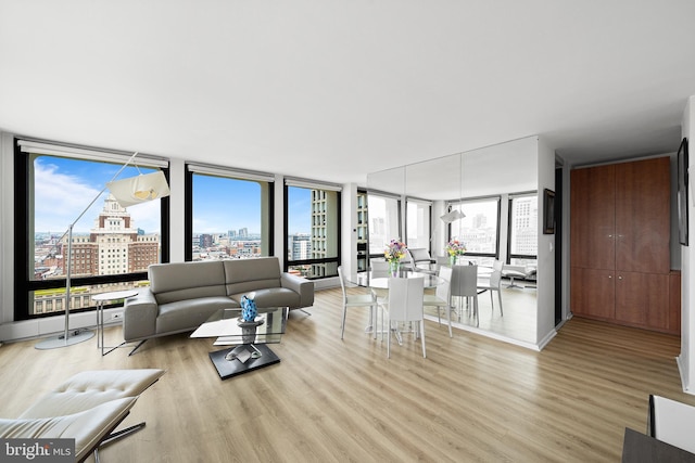 210 Locust St Unit 19Gw, Philadelphia, PA 19106 - living area with expansive windows, a view of city, wood finished floors, and plenty of natural light