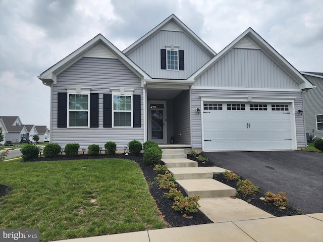 114 Furies St, Smyrna, DE 19977 - view of front of home with board and batten siding, driveway, a front lawn, and a garage