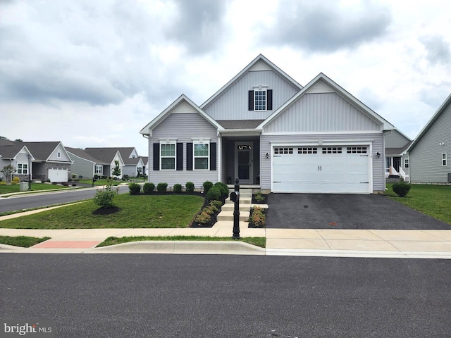 114 Furies St, Smyrna, DE 19977 - view of front of property featuring driveway, board and batten siding, a front yard, and a garage