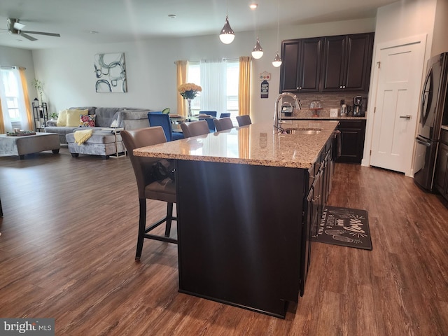 114 Furies St, Smyrna, DE 19977 - kitchen featuring a sink, a kitchen bar, fridge, open floor plan, and dark wood-style floors