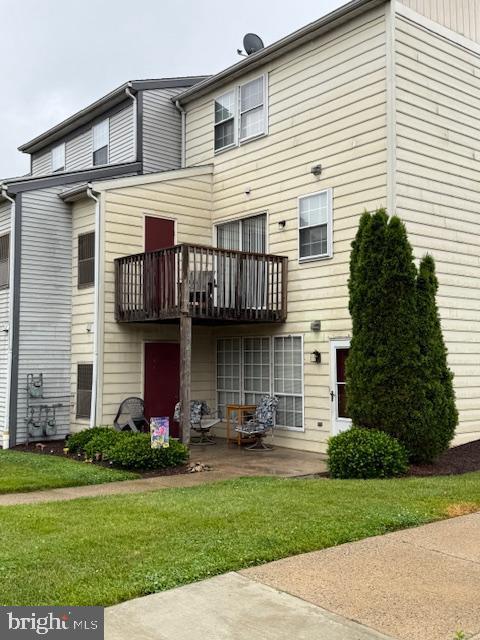 412 Terry Ct Unit A1, Frederick, MD 21701 - rear view of property with a balcony, a patio, and a lawn