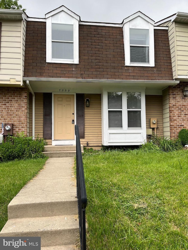 7539 Rain Flower Way, Columbia, MD 21046 - view of property featuring brick siding, a front lawn, and a shingled roof