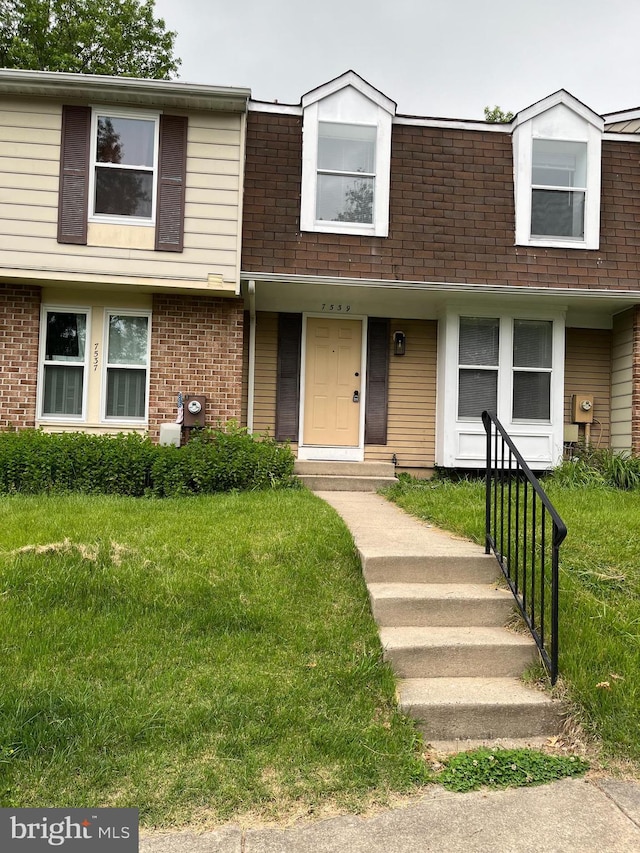 7539 Rain Flower Way, Columbia, MD 21046 - townhome / multi-family property with a front lawn and brick siding