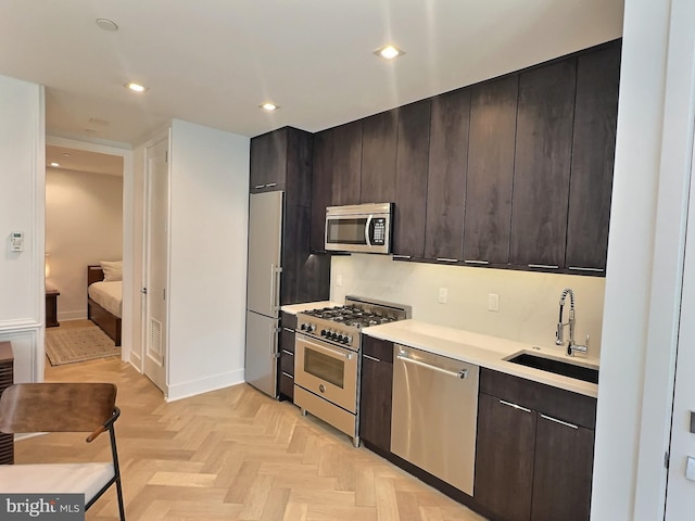 1753 Willard St NW Unit 3, Washington, DC 20009 - kitchen with stainless steel appliances, a sink, light countertops, dark brown cabinets, and recessed lighting