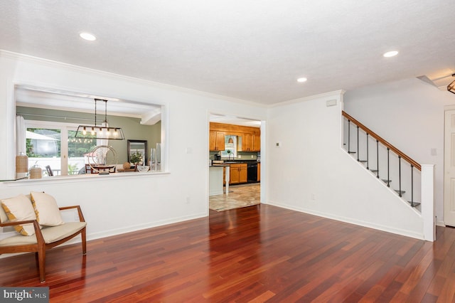 74 Piney Ridge Ln, North East, MD 21901 - unfurnished living room featuring dark wood-type flooring, ornamental molding, recessed lighting, stairs, and a sink
