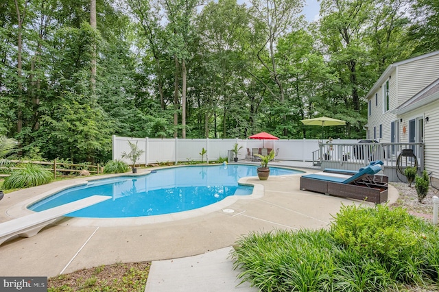 74 Piney Ridge Ln, North East, MD 21901 - view of swimming pool with a fenced backyard, view of scattered trees, a diving board, and a deck