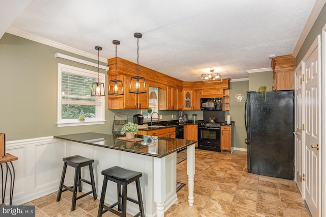 74 Piney Ridge Ln, North East, MD 21901 - kitchen featuring black appliances, a peninsula, brown cabinets, a sink, and pendant lighting