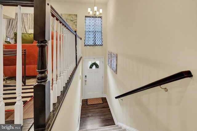8346 Daydream Cres, Pasadena, MD 21122 - stairway featuring a chandelier, wood finished floors, and baseboards