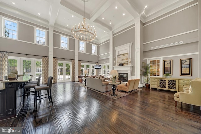 8346 Daydream Cres, Pasadena, MD 21122 - living area featuring a towering ceiling, plenty of natural light, coffered ceiling, beam ceiling, and a glass covered fireplace