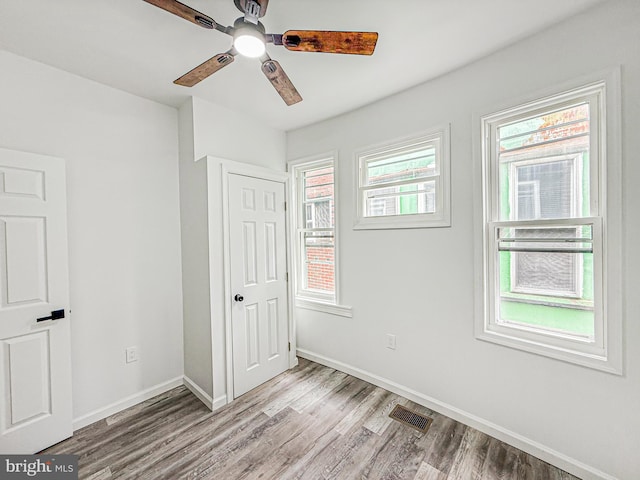 5849 Washington Ave, Philadelphia, PA 19143 - unfurnished bedroom with light wood-style flooring, baseboards, a ceiling fan, and a closet