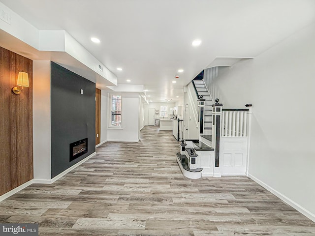 5849 Washington Ave, Philadelphia, PA 19143 - workout room with wood finished floors, recessed lighting, baseboards, and a glass covered fireplace