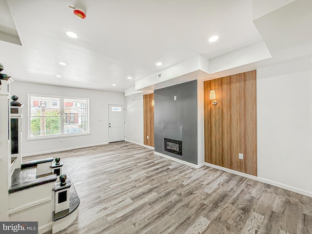 5849 Washington Ave, Philadelphia, PA 19143 - unfurnished living room with a fireplace, wood finished floors, baseboards, and recessed lighting