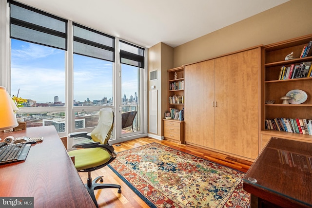 901 N Penn St Unit F2003, Philadelphia, PA 19123 - home office with light wood-style floors, plenty of natural light, a city view, and expansive windows