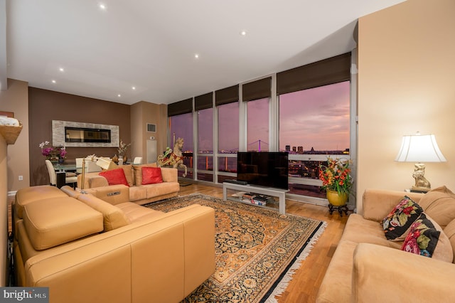 901 N Penn St Unit F2003, Philadelphia, PA 19123 - living area with wood finished floors, a glass covered fireplace, floor to ceiling windows, and recessed lighting