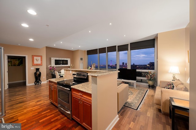 901 N Penn St Unit F2003, Philadelphia, PA 19123 - kitchen featuring open floor plan, electric range, dark wood finished floors, recessed lighting, and light stone counters