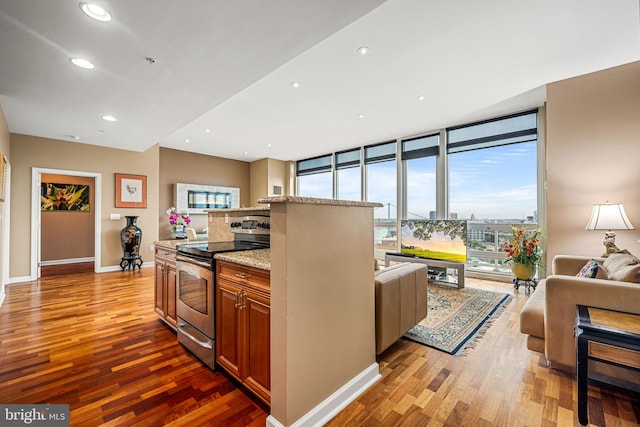 901 N Penn St Unit F2003, Philadelphia, PA 19123 - kitchen with stainless steel electric range, open floor plan, wood finished floors, and recessed lighting
