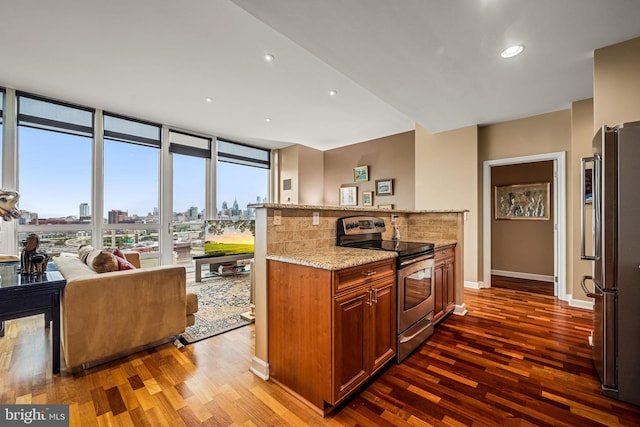 901 N Penn St Unit F2003, Philadelphia, PA 19123 - kitchen with appliances with stainless steel finishes, dark wood-style floors, light stone countertops, open floor plan, and recessed lighting