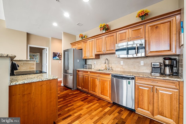 901 N Penn St Unit F2003, Philadelphia, PA 19123 - kitchen featuring stainless steel appliances, a sink, dark wood finished floors, tasteful backsplash, and recessed lighting