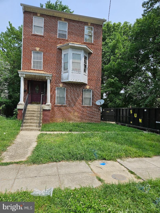 4908 Quarles St NE, Washington, DC 20019 - townhome / multi-family property featuring brick siding and a front lawn