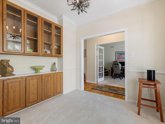 106 Barb Ct, Stephens City, VA 22655 - bar with light carpet, ornamental molding, french doors, and a chandelier