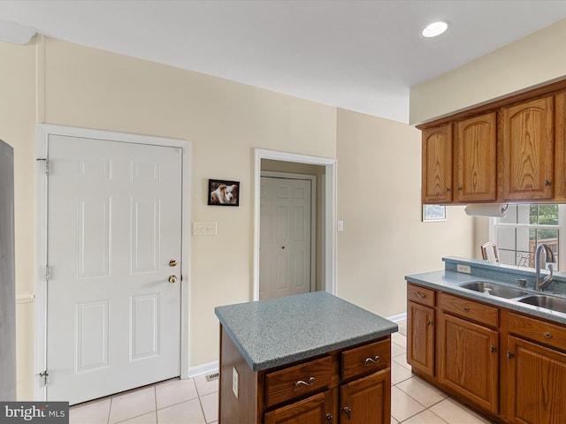 106 Barb Ct, Stephens City, VA 22655 - kitchen with light tile patterned floors, brown cabinetry, a kitchen island, and recessed lighting