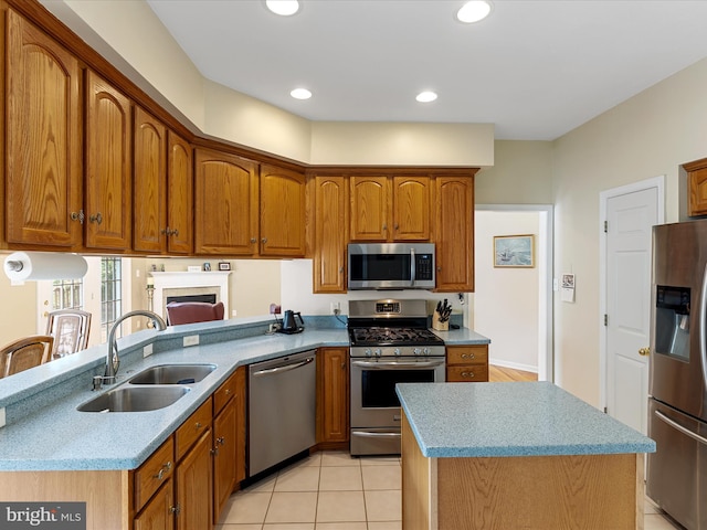 106 Barb Ct, Stephens City, VA 22655 - kitchen with appliances with stainless steel finishes, brown cabinetry, recessed lighting, a peninsula, and a center island
