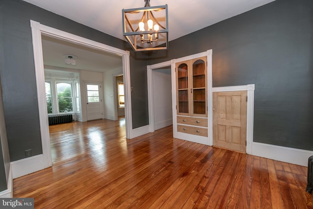 28 Bowen Ave, Woodstown, NJ 08098 - unfurnished dining area with radiator heating unit, a chandelier, hardwood / wood-style floors, and baseboards