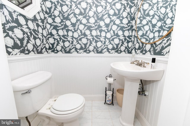 28 Bowen Ave, Woodstown, NJ 08098 - bathroom featuring a wainscoted wall, marble look tile flooring, toilet, wallpapered walls, and a sink