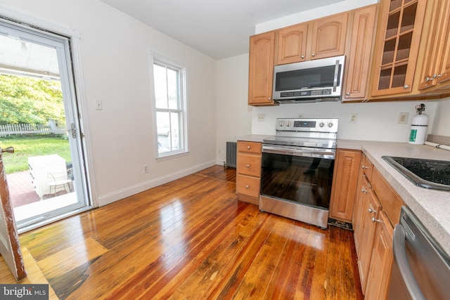 28 Bowen Ave, Woodstown, NJ 08098 - kitchen featuring appliances with stainless steel finishes, hardwood / wood-style flooring, radiator heating unit, and light countertops