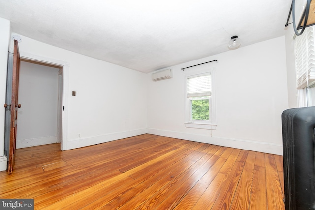 28 Bowen Ave, Woodstown, NJ 08098 - empty room featuring a wall mounted AC, light wood-style flooring, and baseboards