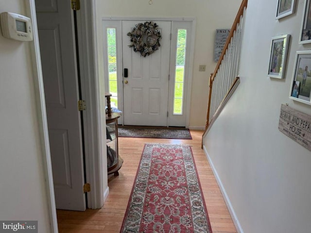 530 Glenhaven Dr, Glenshaw, PA 15116 - foyer entrance featuring light wood finished floors, stairway, and baseboards