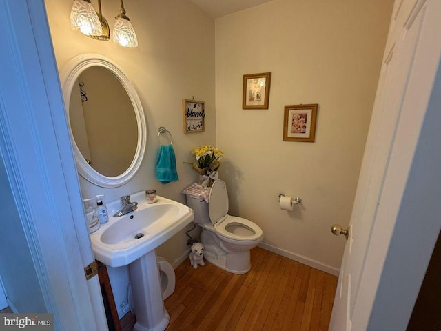 530 Glenhaven Dr, Glenshaw, PA 15116 - bathroom with toilet, wood finished floors, and baseboards