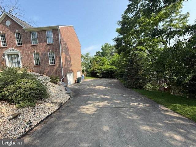 530 Glenhaven Dr, Glenshaw, PA 15116 - view of property exterior featuring asphalt driveway, an attached garage, and brick siding