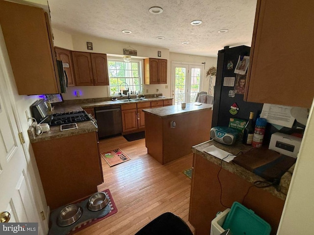 530 Glenhaven Dr, Glenshaw, PA 15116 - kitchen featuring dishwasher, light wood-style flooring, a sink, a textured ceiling, and a center island