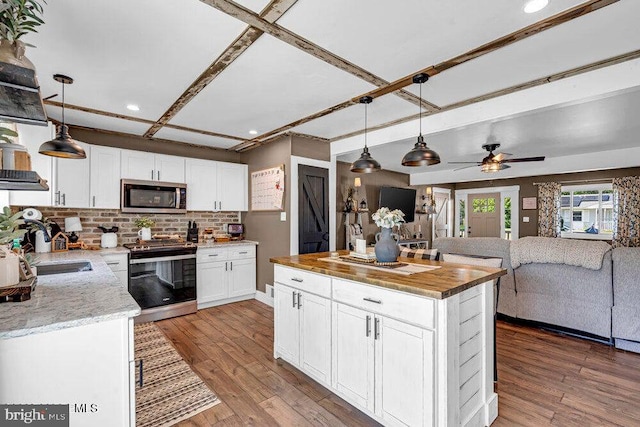 111 Lawrence Dr, Lanoka Harbor, NJ 08734 - kitchen featuring stainless steel appliances, a sink, open floor plan, tasteful backsplash, and white cabinets