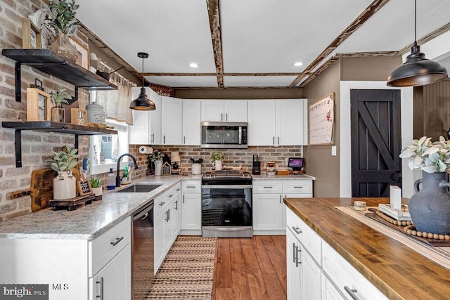 111 Lawrence Dr, Lanoka Harbor, NJ 08734 - kitchen with appliances with stainless steel finishes, a sink, light wood finished floors, white cabinetry, and recessed lighting