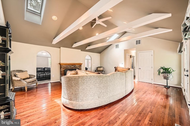 3528 Cohasset Ave, Annapolis, MD 21403 - living room with arched walkways, beam ceiling, hardwood / wood-style flooring, high vaulted ceiling, and a fireplace