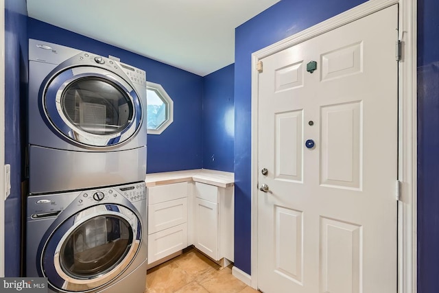 3528 Cohasset Ave, Annapolis, MD 21403 - laundry room with estacked washer and dryer, light tile patterned floors, and cabinet space