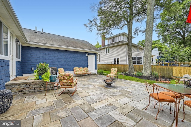 3528 Cohasset Ave, Annapolis, MD 21403 - fenced backyard with a patio, outdoor dining area, and an outdoor fire pit