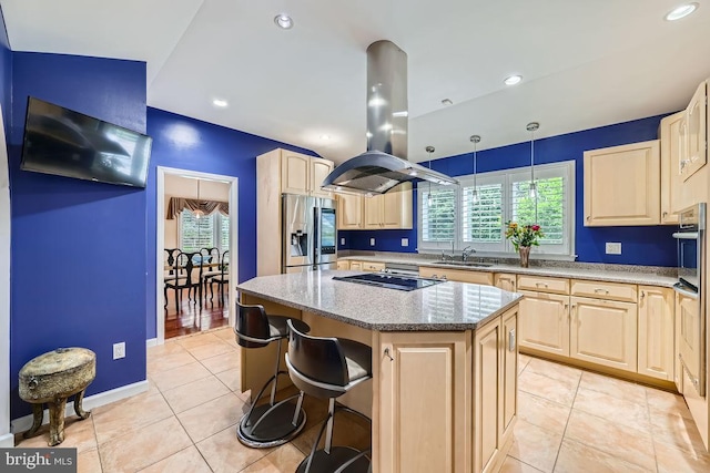 3528 Cohasset Ave, Annapolis, MD 21403 - kitchen with stainless steel fridge with ice dispenser, light brown cabinetry, island exhaust hood, light stone counters, and a kitchen island