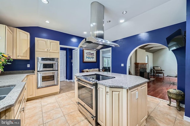 3528 Cohasset Ave, Annapolis, MD 21403 - kitchen with stainless steel appliances, arched walkways, light brown cabinets, open floor plan, and lofted ceiling